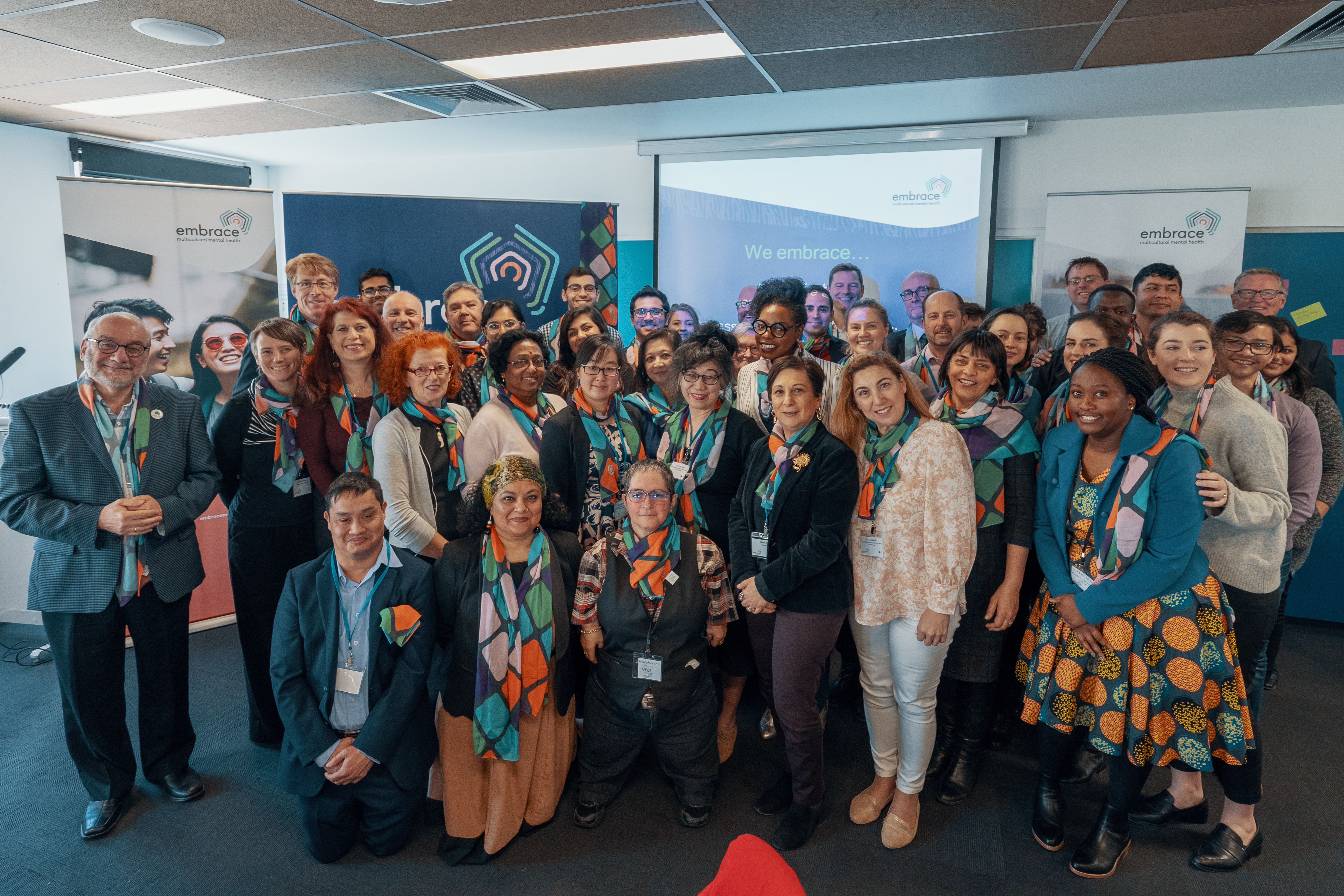 Group photo of launch attendees smiling together